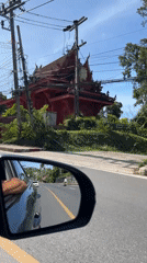 Driver records traditional Thai building in Baan Hua Thanon