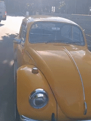 Yellow VW Beetle spotted near Tallinn ruins on a sunny afternoon