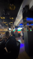 Modern restaurant interior captured during evening event in Pazardzhik