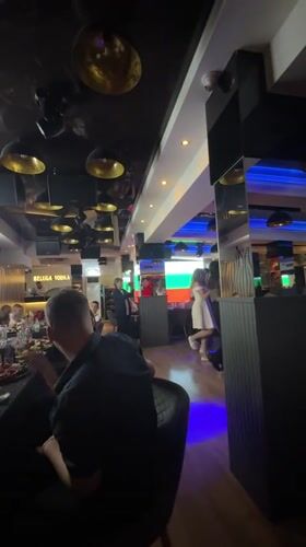 Modern restaurant interior captured during evening event in Pazardzhik