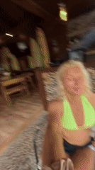 Woman records post-surf selfie video in bikini top