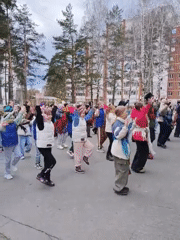 Children perform synchronized outdoor dance routine with traditional dress