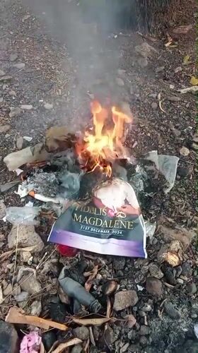 Ground fire burns amid trash and campaign debris in Akwanga
