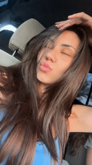 Woman poses, winks at camera inside car in Bulgaria