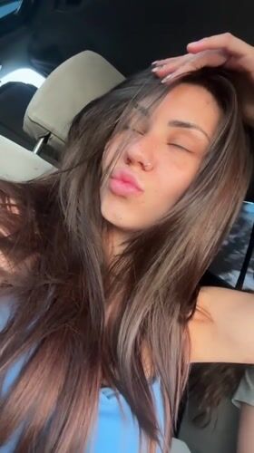 Woman poses, winks at camera inside car in Bulgaria