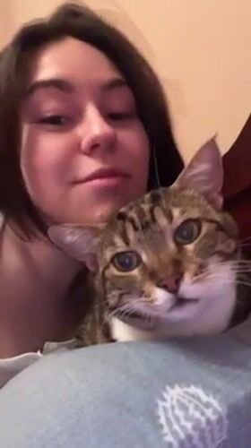 Woman and tabby cat share quiet moments in Odesa bedroom