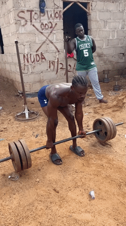 Outdoor weightlifting session documented in Akwanga, Nigeria residential area