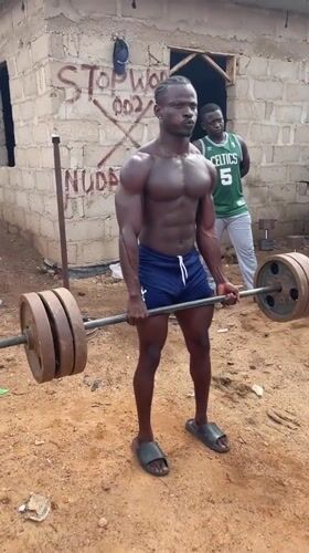 Outdoor weightlifting session documented in Akwanga, Nigeria residential area