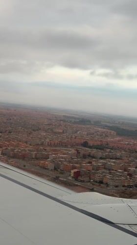 Passenger films aerial view of Marrakesh from airplane window