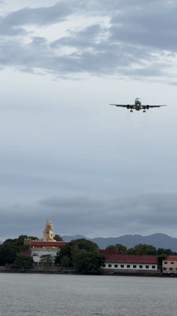 Plane on final approach over Ko Samui's coastal waters