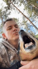 Person interacts with dog in Chuprino, Russia