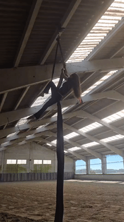 Aerial silks performer practices routines in Belgian indoor facility