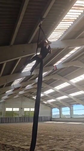 Aerial silks performer practices routines in Belgian indoor facility