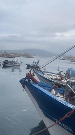 Evening harbor life captured in M'Diq, Morocco fishing port