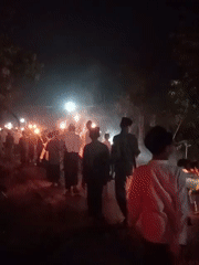 Torch procession moves through the night in Bendorejo