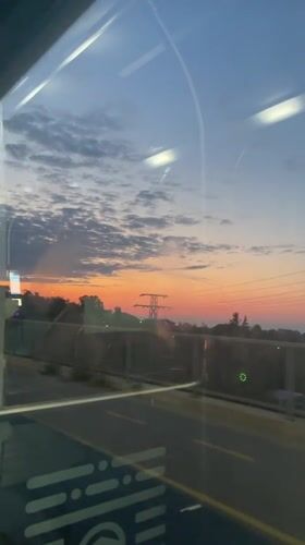 Sunset reflects through a window over Varna's skyline