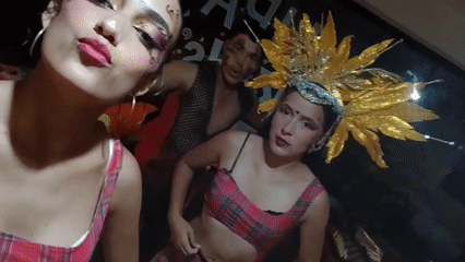 Friends take selfies with theatrical makeup in Venezuela beach town