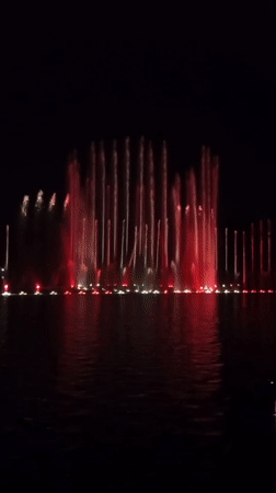 Colorful illuminated fountain display on a Wrocław summer night