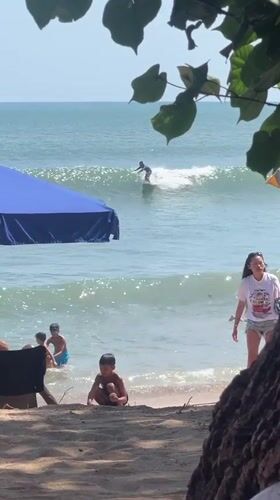 Kuta Beach in full swing: surf, sand, and shoreline activity