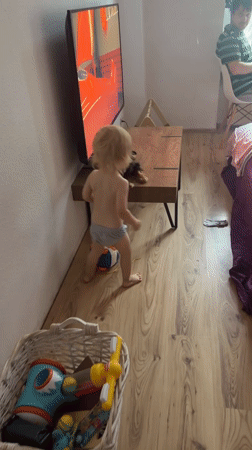 Puppy and toddler share a lazy afternoon at home in Wuppertal