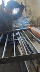Welder works on metal gate construction in Burgas