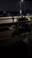Group gathers around stopped sedan in Offatedo, Nigeria