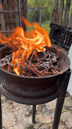 Makeshift fire pit burns twigs in Bulgarian village