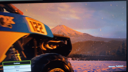 Gaming and luxury car displays captured at unknown location