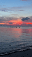 Sunset beach scene with colorful sky documented by witness