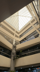 Multi-story building interior with pyramid skylight captured in Porlamar