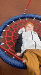 Child plays on nest swing at Sochi playground