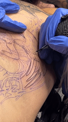 Tattoo artist works on angel design in Buenos Aires
