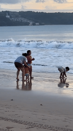 Family enjoys morning beach time in Kuta, Indonesia