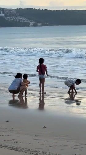 Family enjoys morning beach time in Kuta, Indonesia