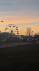 Sunset Ferris wheel creates striking silhouette over Riga skyline