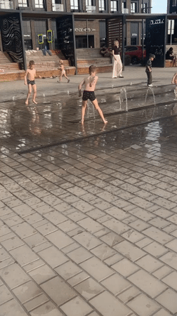 Children play in fountain on sunny day in Astrakhan