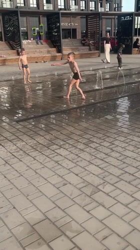 Children play in fountain on sunny day in Astrakhan