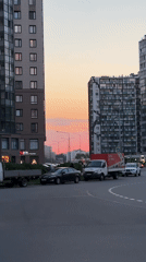 Sunset colors illuminate modern buildings in Kudrovo, Russia