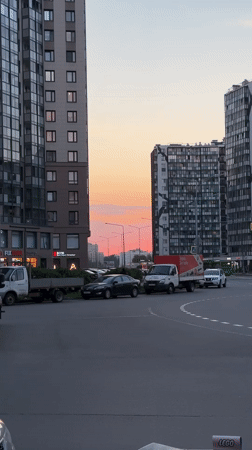 Sunset colors illuminate modern buildings in Kudrovo, Russia