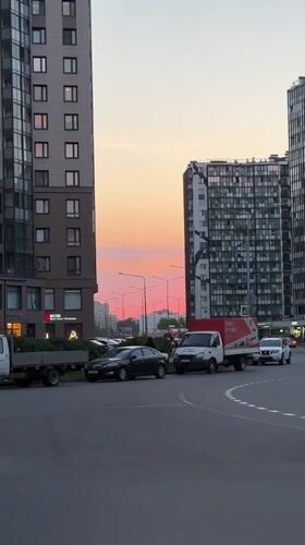 Sunset colors illuminate modern buildings in Kudrovo, Russia