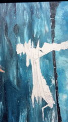 Artist removes stencil from blue painted surface in Spain