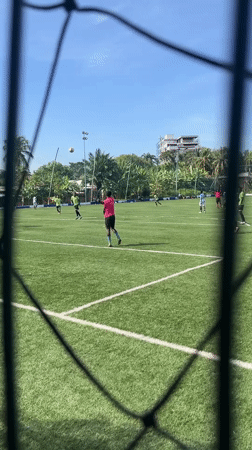 Soccer match played on turf field in Accra