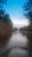 Drivers navigate wet, pothole-marked roads after recent rainfall