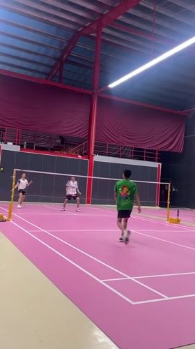 Badminton doubles match played on pink court in Ko Samui