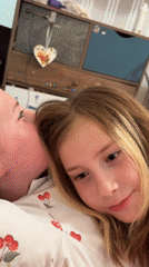 Girl smiles on cherry pillow in Veliky Novgorod