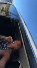 Woman filmed in passenger seat during sunny drive in Indio