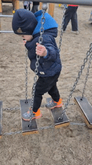 Children play at Tobolsk playground amid city skyline