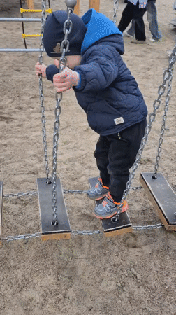 Children play at Tobolsk playground amid city skyline