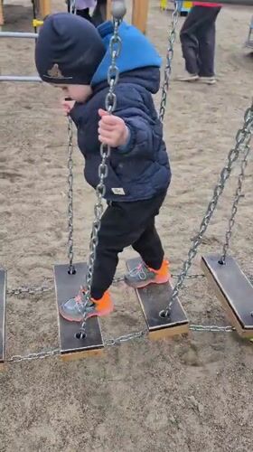 Children play at Tobolsk playground amid city skyline