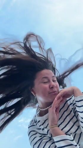 Low-angle sky shots with windswept hair near Sapernyy, Russia